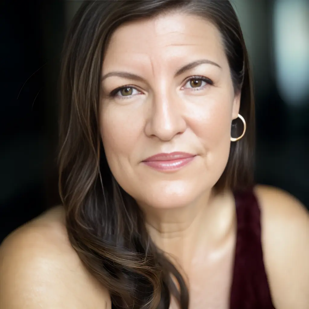 Coach Mihaela with a warm smile headshot AI enhanced